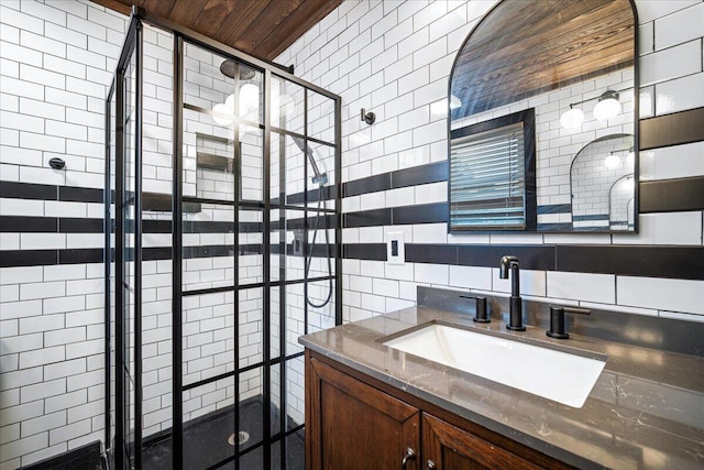 bathroom with a stall shower, backsplash, tile walls, and vanity