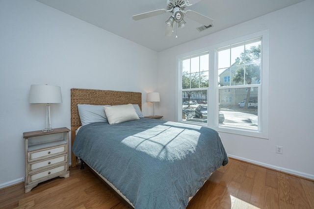 bedroom with ceiling fan and wood-type flooring