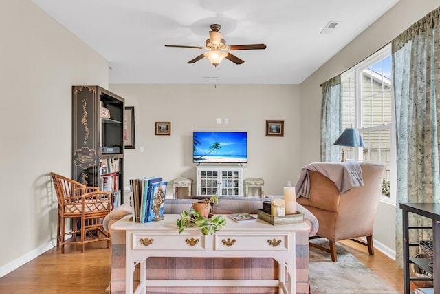 living room featuring ceiling fan and light wood-type flooring