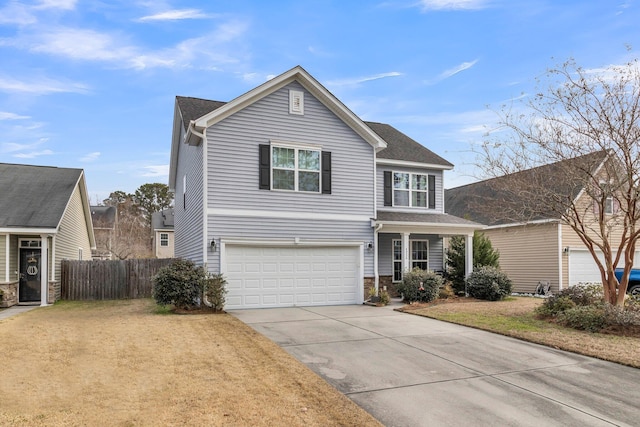 view of property featuring a garage and a front lawn