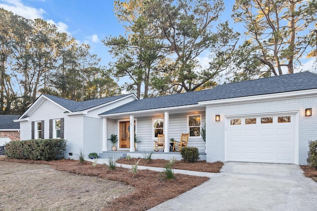 ranch-style house with a garage and covered porch