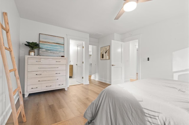 bedroom featuring wood-type flooring, connected bathroom, and ceiling fan