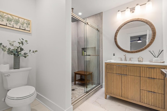 bathroom featuring vanity, a shower with shower door, and toilet