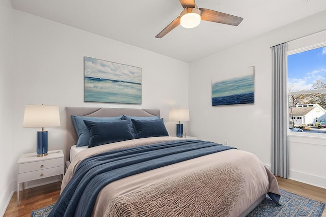 bedroom with dark wood-type flooring and ceiling fan