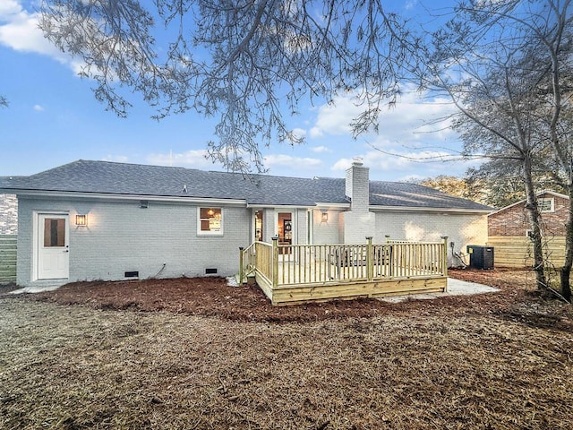 rear view of property featuring a wooden deck and central AC