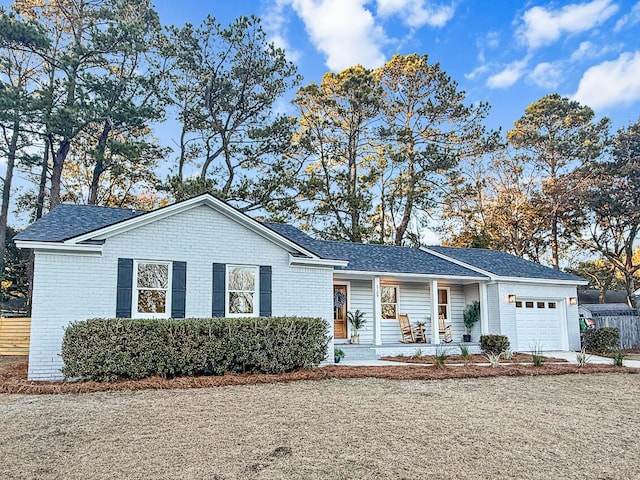 ranch-style home with a garage and covered porch