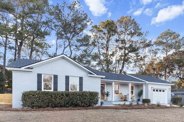 single story home with a garage and covered porch