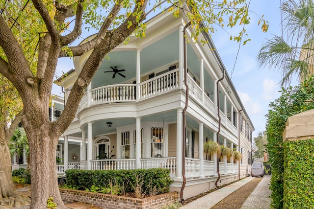 view of front facade featuring covered porch, ceiling fan, and a balcony