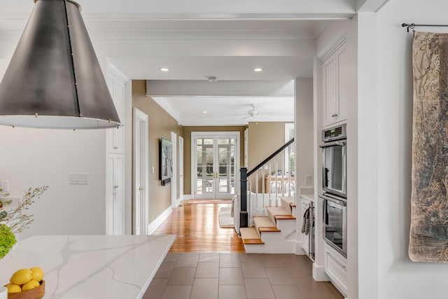 corridor with recessed lighting, wood finished floors, stairs, french doors, and ornamental molding