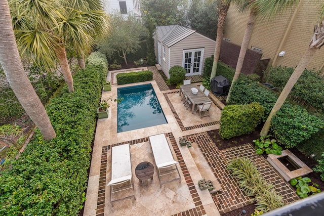 pool featuring an outbuilding, french doors, and a patio