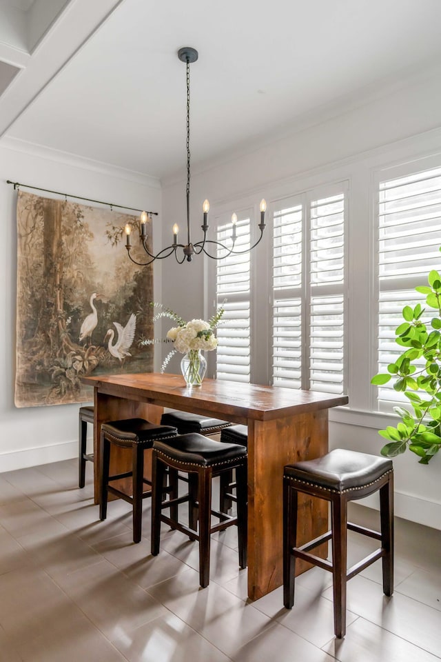 dining room featuring baseboards and ornamental molding