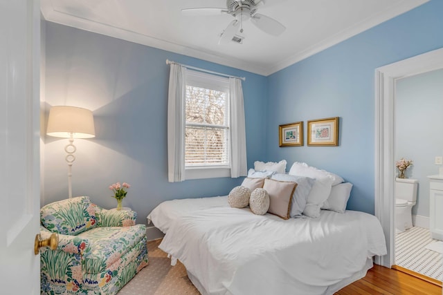 bedroom with a ceiling fan, ornamental molding, wood finished floors, and ensuite bathroom