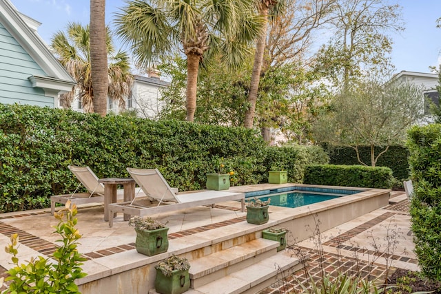 pool featuring a patio area and fence