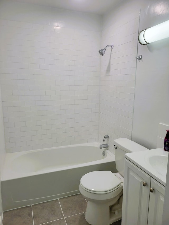 full bathroom with toilet, vanity, tiled shower / bath, and tile patterned flooring