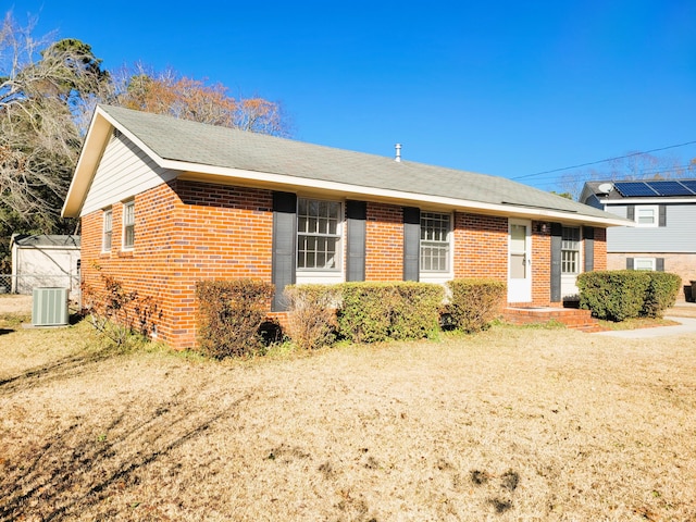 view of front of home featuring a front lawn and central air condition unit