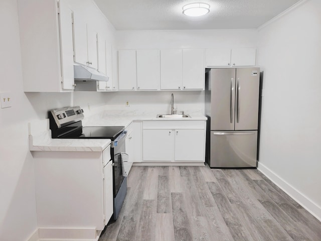 kitchen with a textured ceiling, stainless steel appliances, white cabinets, and sink