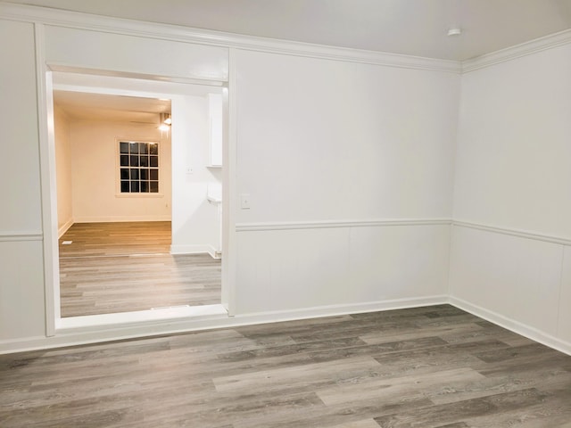 spare room featuring crown molding and hardwood / wood-style floors