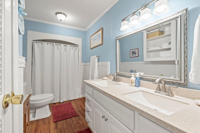 bathroom with a textured ceiling, hardwood / wood-style flooring, crown molding, and toilet