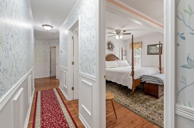 bedroom with hardwood / wood-style floors and a textured ceiling