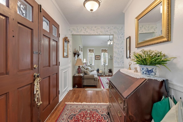 foyer featuring hardwood / wood-style flooring and crown molding