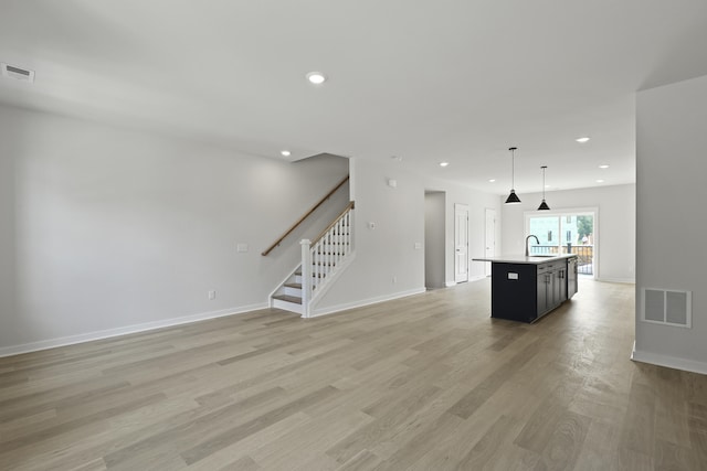 564 Scholar Way, Summerville, SC 29486 - unfurnished living room with stairway, light wood-type flooring, and recessed lighting