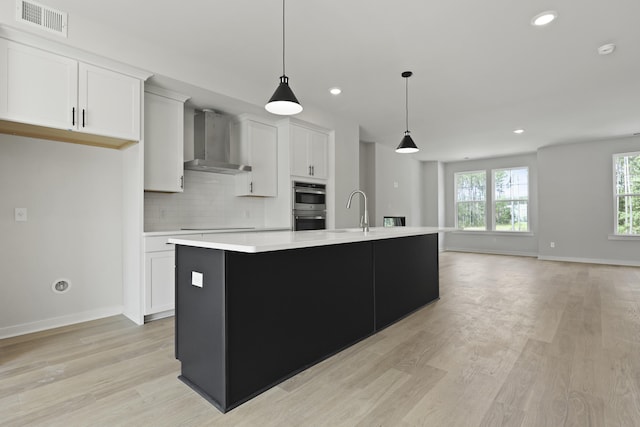 564 Scholar Way, Summerville, SC 29486 - kitchen featuring wall chimney exhaust hood, double oven, light countertops, recessed lighting, and an island with sink