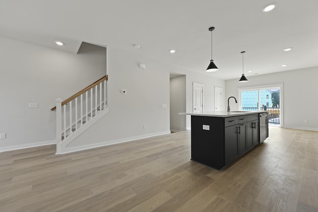 564 Scholar Way, Summerville, SC 29486 - kitchen with stainless steel dishwasher, an island with sink, dark cabinetry, light wood-type flooring, and recessed lighting