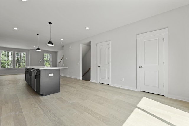 564 Scholar Way, Summerville, SC 29486 - kitchen featuring light countertops, a kitchen island with sink, light wood-type flooring, recessed lighting, and pendant lighting