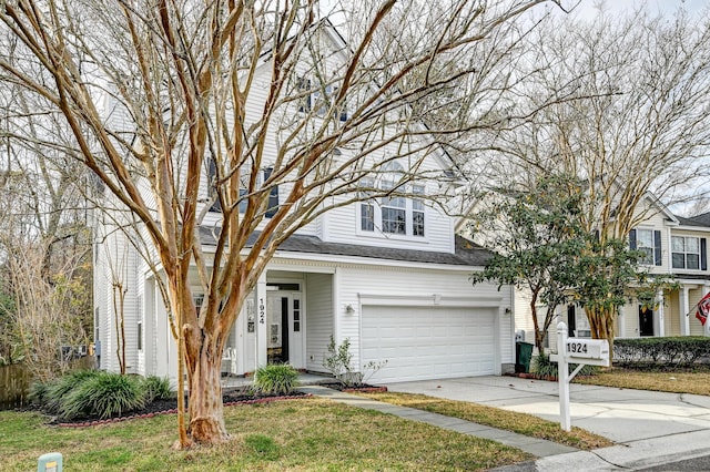 view of front facade featuring a front yard, driveway, and a shingled roof