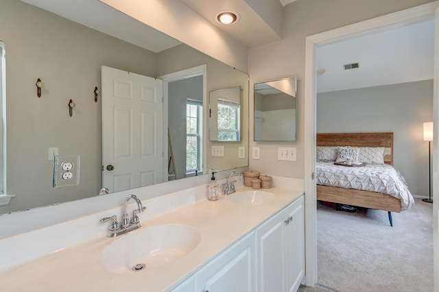 bathroom featuring double vanity, visible vents, and a sink