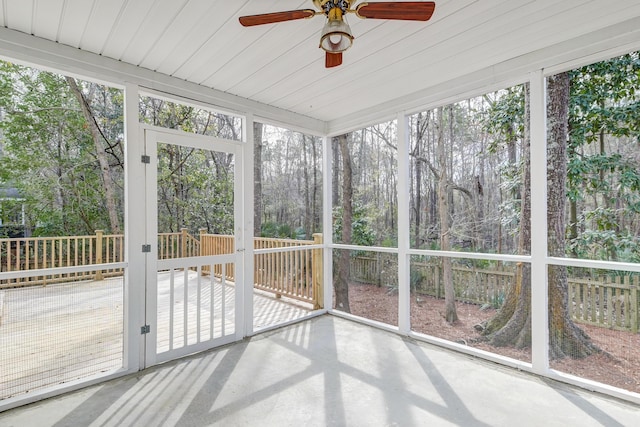 unfurnished sunroom featuring ceiling fan