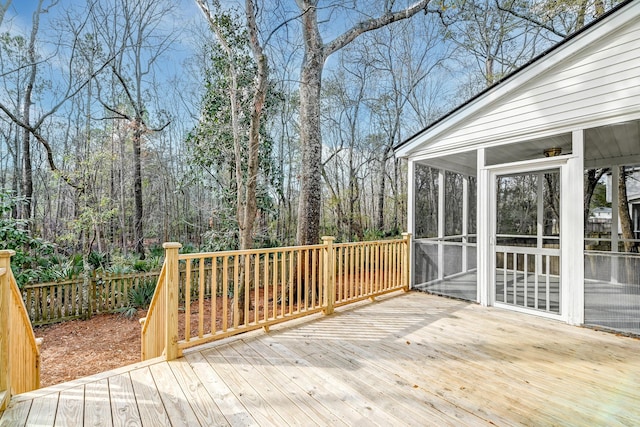 wooden terrace with fence and a sunroom