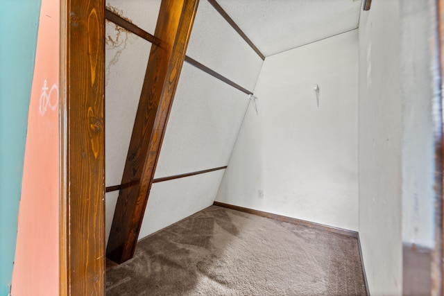 spacious closet with carpet flooring and vaulted ceiling