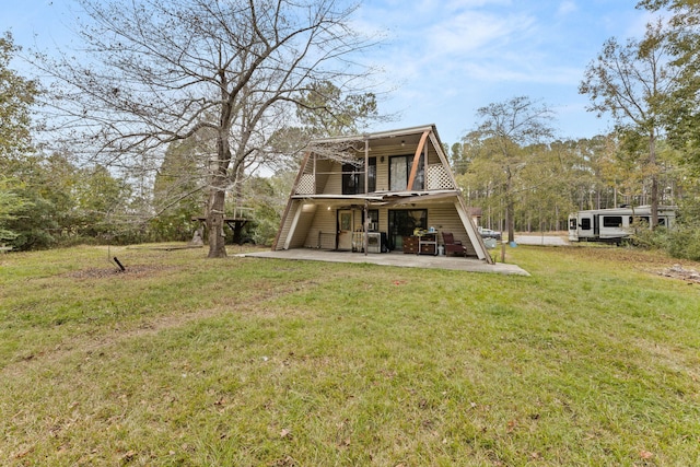 rear view of property with a patio area and a lawn