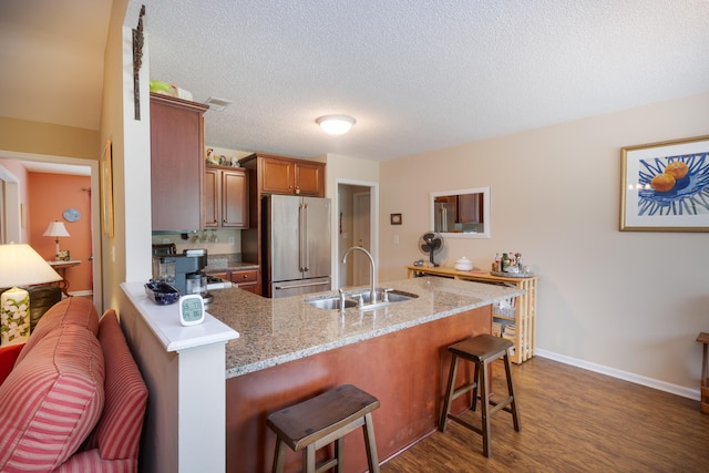 160 Syrr Run Rd, Saint George, SC 29477 - kitchen with high quality fridge, a sink, a peninsula, dark wood-style floors, and a breakfast bar area