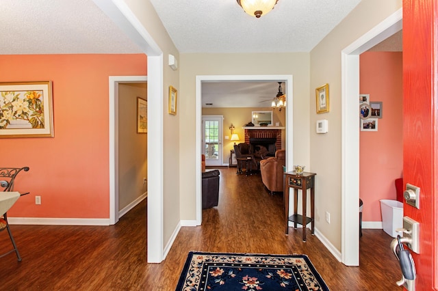 160 Syrr Run Rd, Saint George, SC 29477 - entrance foyer featuring dark wood finished floors, a fireplace, baseboards, ceiling fan, and a textured ceiling