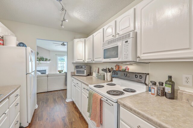 kitchen with ceiling fan, white appliances, a textured ceiling, dark wood-type flooring, and white cabinetry