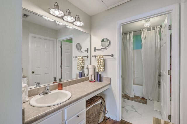 bathroom featuring shower / bath combination with curtain and vanity