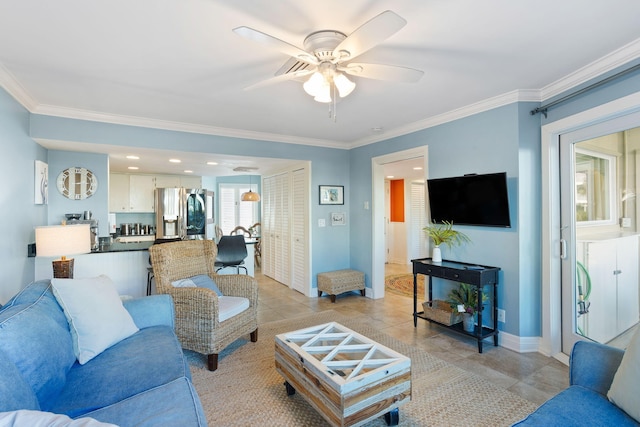 living room with ceiling fan and crown molding