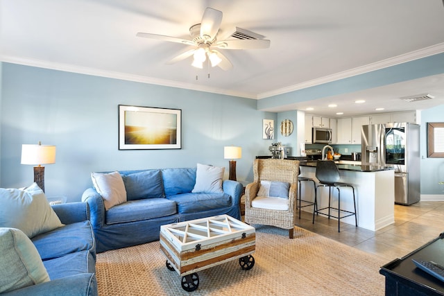 living room featuring crown molding, light tile patterned floors, and ceiling fan