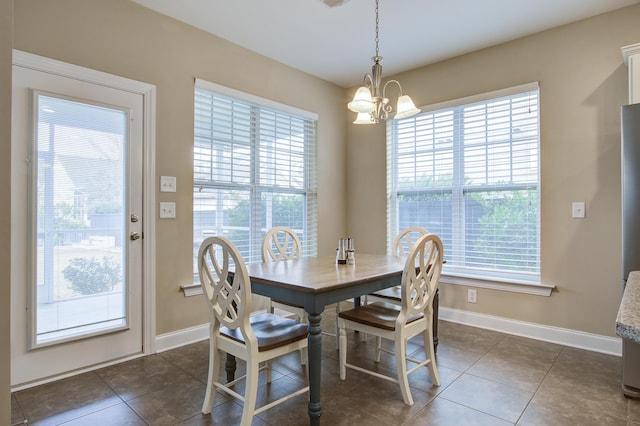 tiled dining area with an inviting chandelier