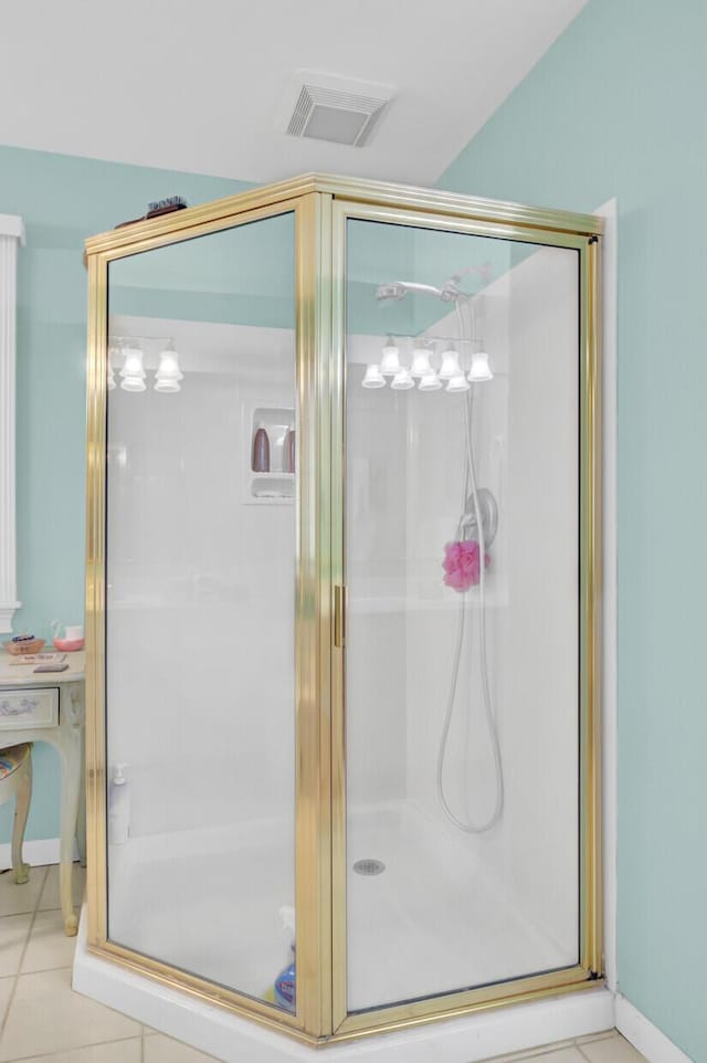 bathroom with tile patterned flooring, a shower stall, and visible vents