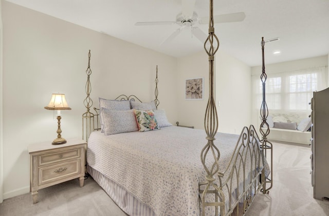 bedroom with a ceiling fan and light colored carpet