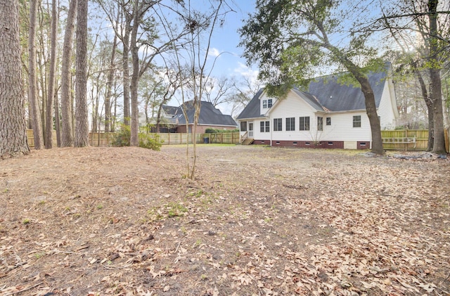 back of property featuring crawl space and a fenced backyard