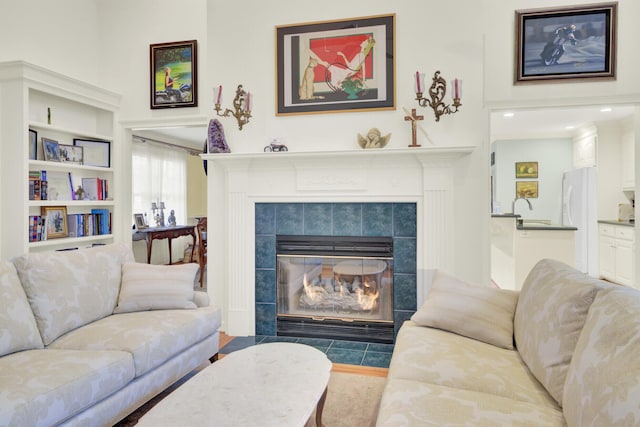 living area with a tile fireplace