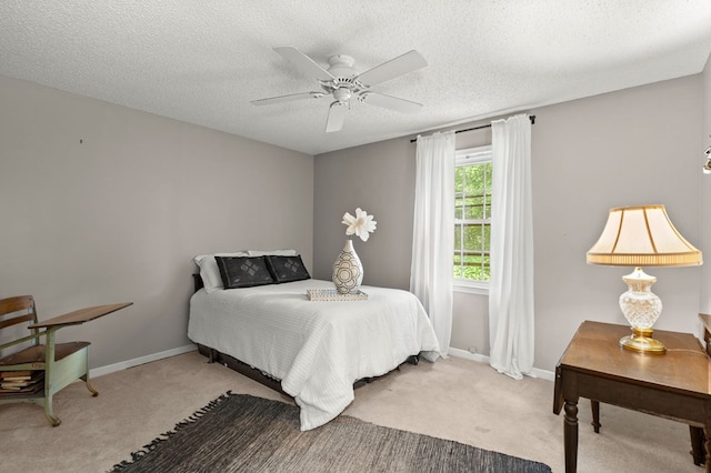 carpeted bedroom with a textured ceiling and ceiling fan