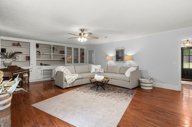 living room with ornamental molding, ceiling fan, dark hardwood / wood-style floors, and a textured ceiling