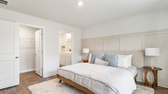 518 Golden Embers Way, Summerville, SC 29486 - bedroom with a spacious closet, wood finished floors, ensuite bathroom, and baseboards