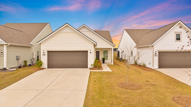 view of front of house with driveway, a front yard, and an attached garage