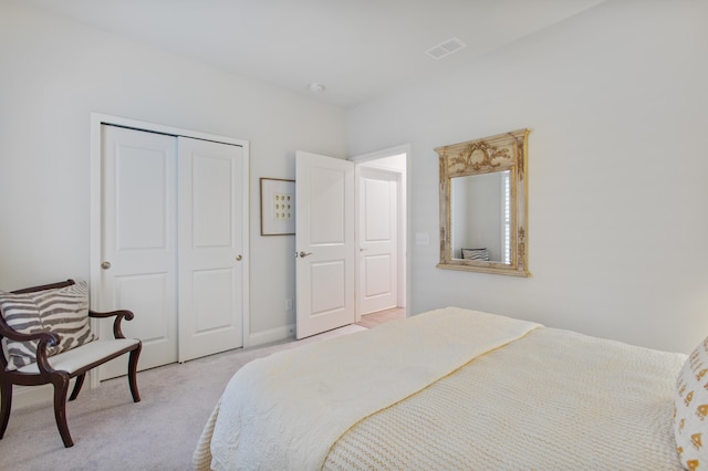 carpeted bedroom with a closet and visible vents